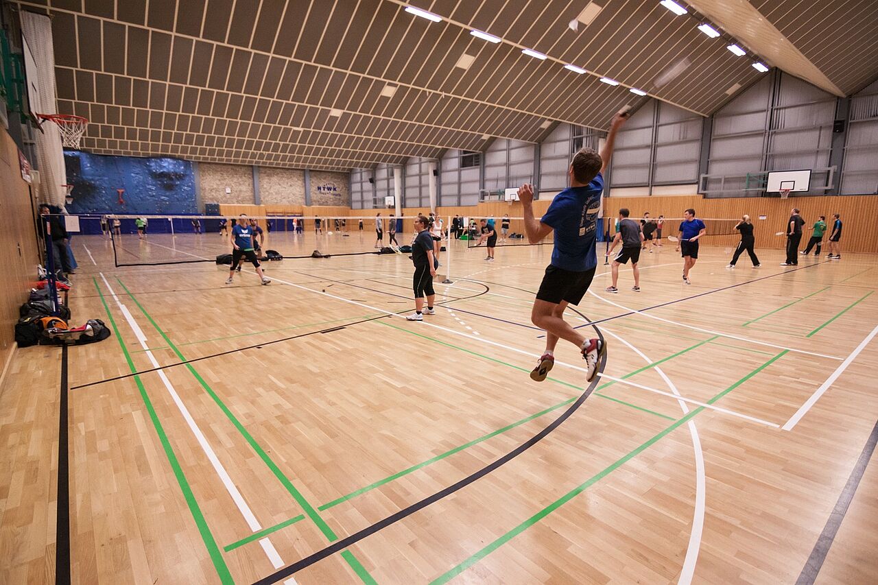 People playing badminton in the sports hall