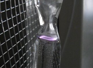 GreenHydroSax Purple plasma arc visible in a glass reactor
