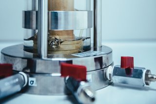 Close-up of a cylindrical laboratory setup with soil samples