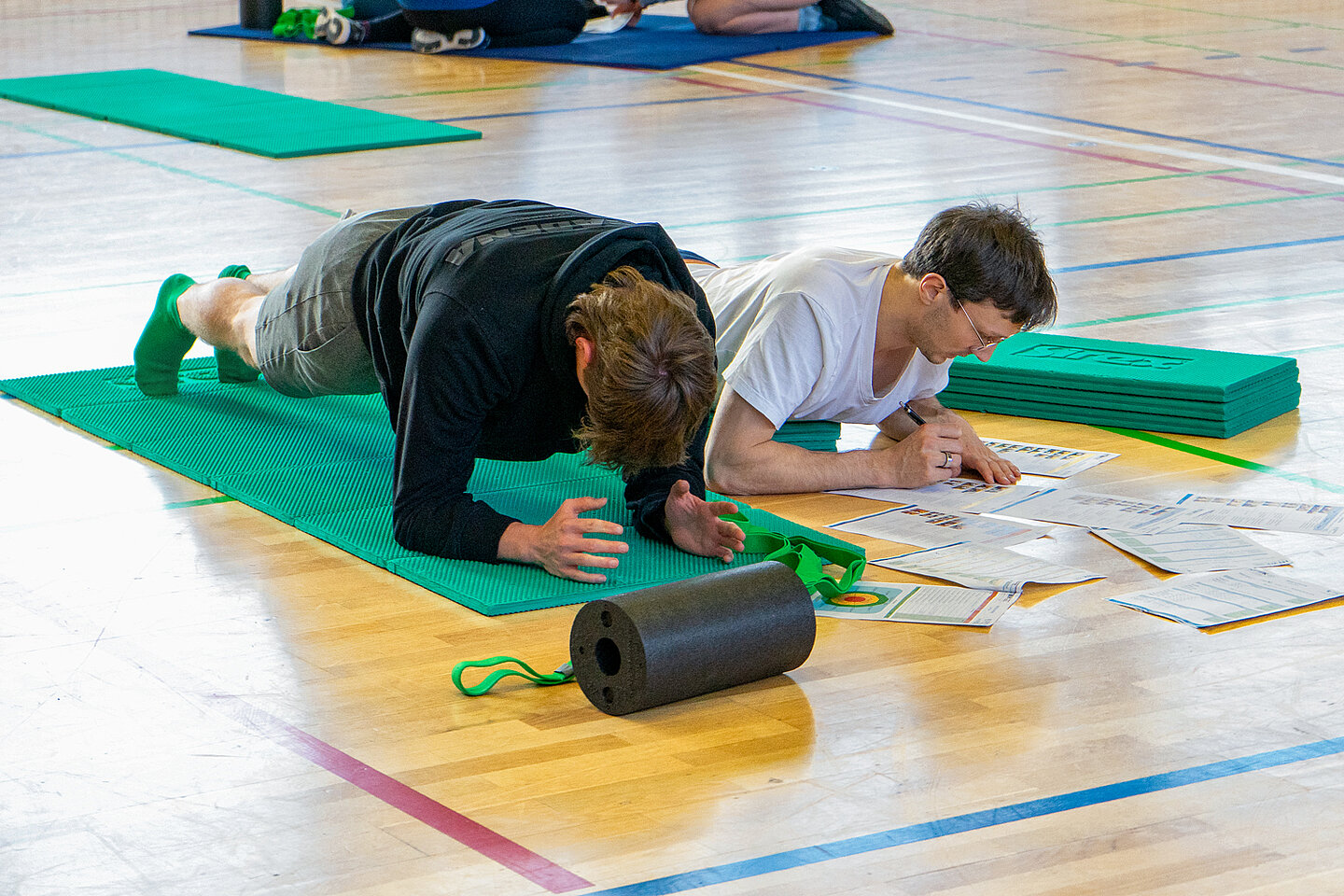 zwei Männer üben auf einer Sportmatte