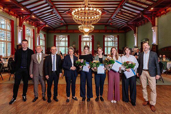 Gruppe von Personen mit Blumensträußen
