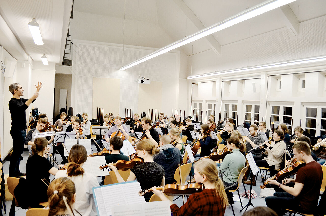 Orchestra rehearsal in a large room at the university