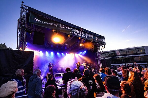 Live-Musik auf der Bühne des Festivals "Leipzig zeigt Courage" Ein Blick aus der Besuchermenge auf die Bühne des Festivals bei Sonnenuntergang.