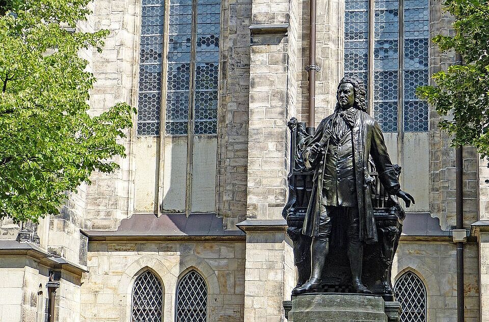 The monument of Johann Sebastian Bach in front of the Thomas church in Leipzig