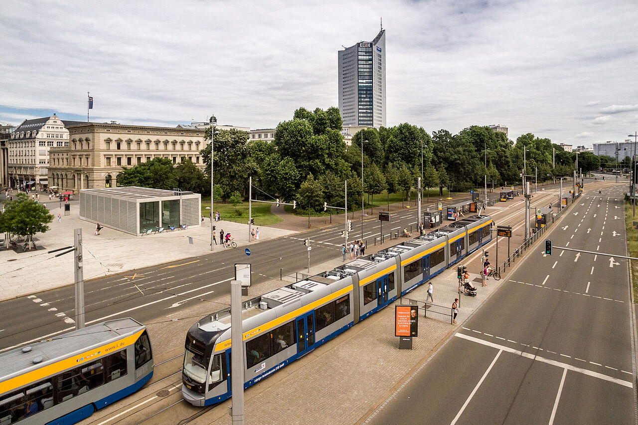 Aerial view of a streetcar stop, with the tall City-Hochhaus and other buildings in the background