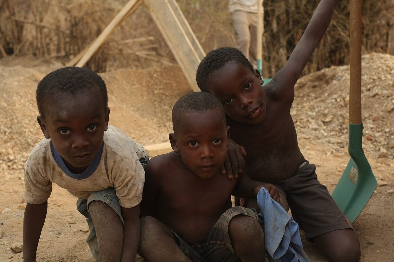 Drei togolesische Kinder schauen frontal in die Kamera.