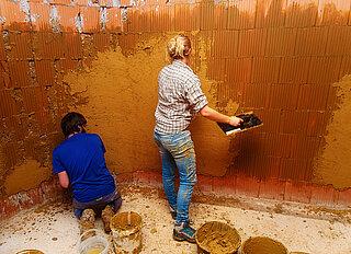 LPP Two people are plastering the wall
