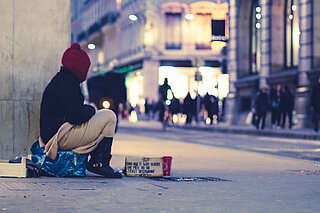 INTERACT The photo shows a homeless woman in a major city
