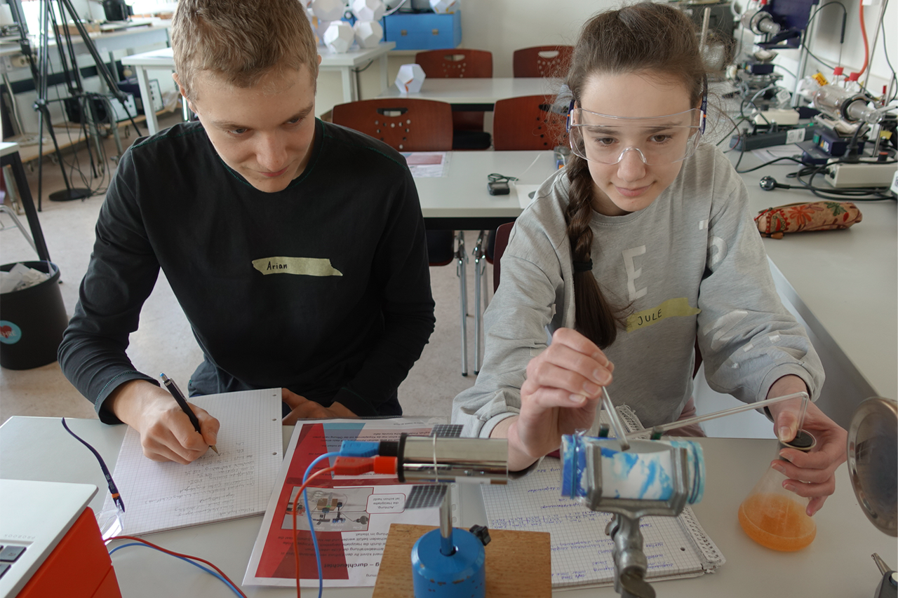 ExperiWatt 2024: Schüler und Schülerin an der Universität Leipzig beim Experiment Brennbares Eis 