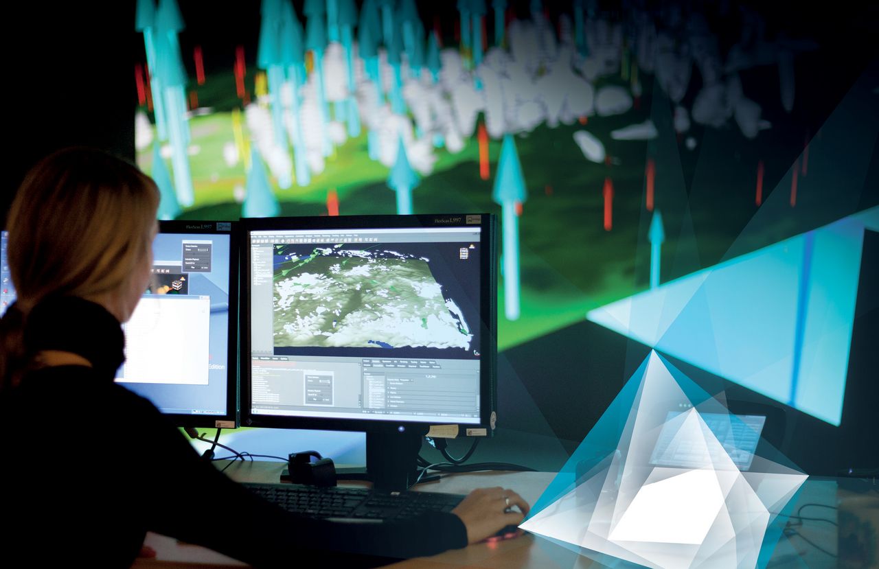 Media & Information (Picture: Kristina Denhof) A woman is working with two screens and an obviously high advanced software