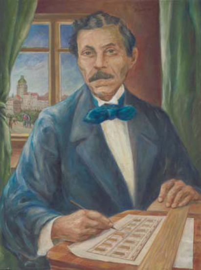 Porträt von Albert Geutebrück wie er an seinem Schreibtisch arbeitet